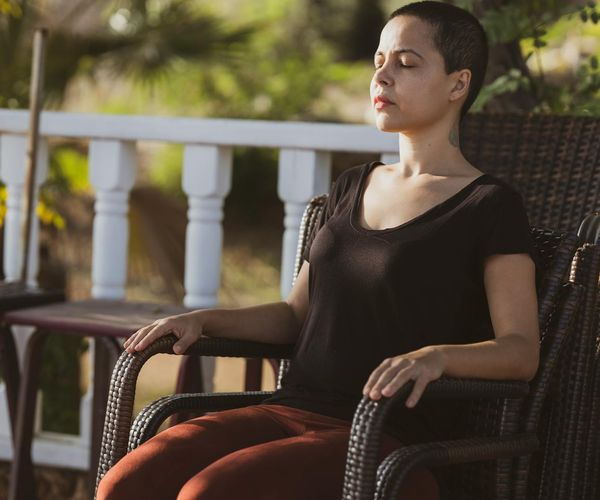 A person sitting in a cross-legged meditation pose in a serene, clean environment.