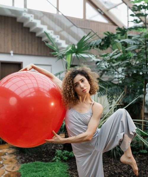 Person holding a powerful warrior yoga pose, symbolizing strength and stability.